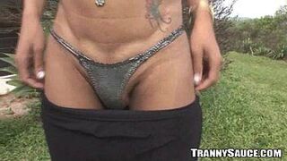 Foxy redhead tranny tugging on her cock outdoors - porn video
